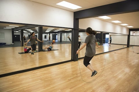 female student doing skip rope exercise