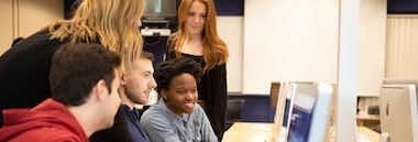 Group of students looking at computer screen